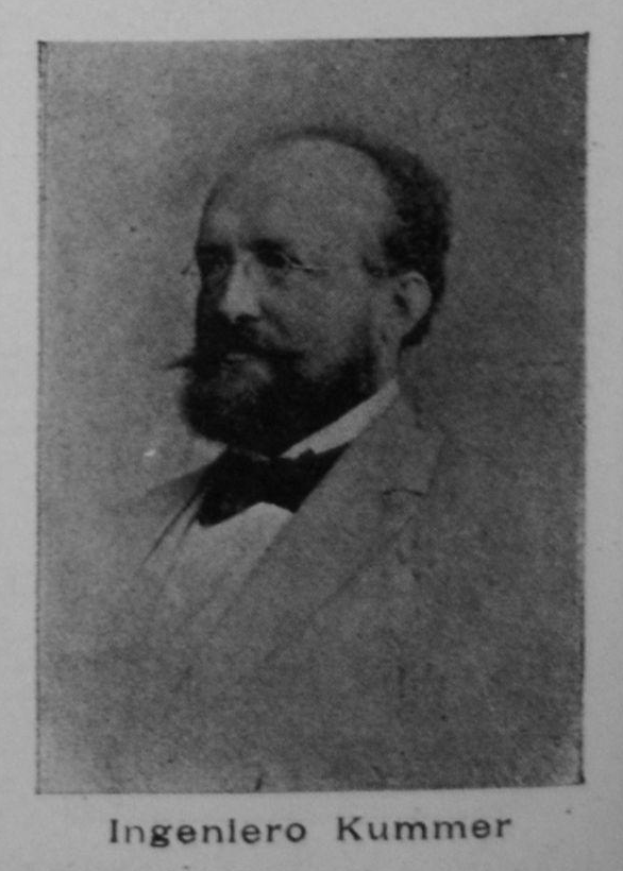 Ein Schwarz-Weiß-Foto eines bärtigen Mannes in einem Blazer und Brille mit dem Text "Ingenlero Kummer, der Gründer der deutschen Revolution" unten.